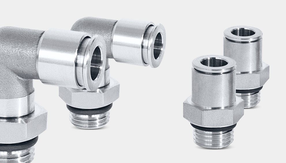 Two angled fittings and next to them two straight fittings, each in stainless steel.