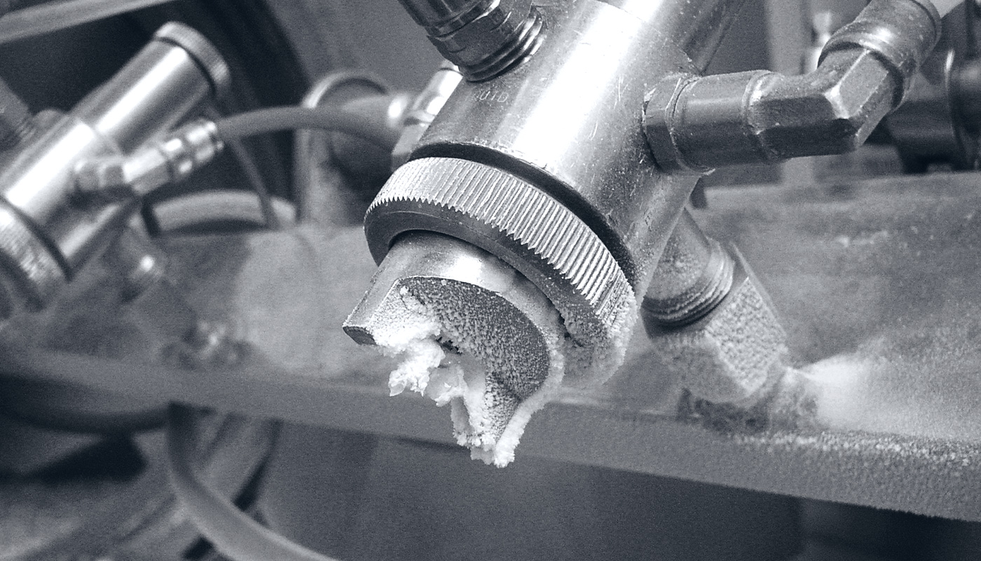 A conventional flat spray nozzle with 'humps' in the production line with clogged air ducts 