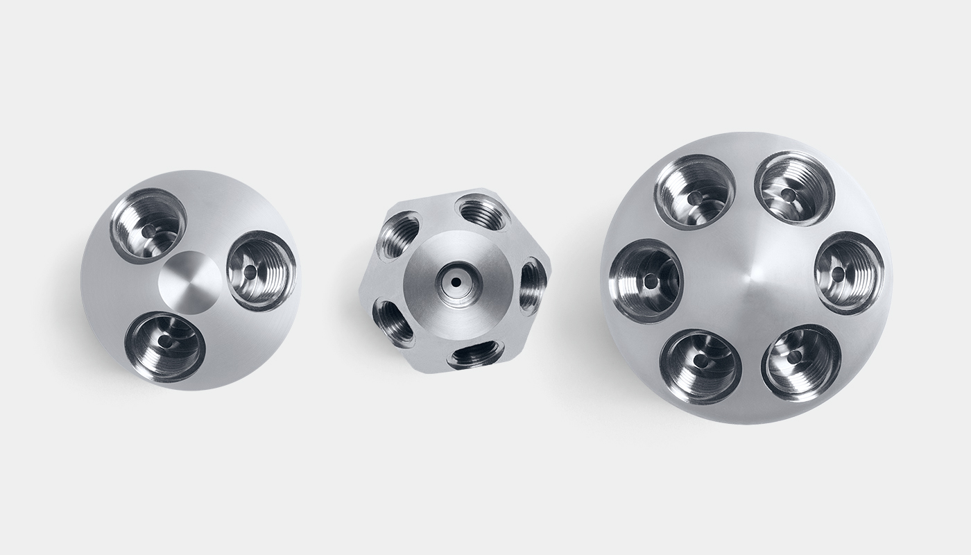 Three different large SCHLICK nozzle head versions side by side. From left to right: 3-head version, 5-head version, 6-head version