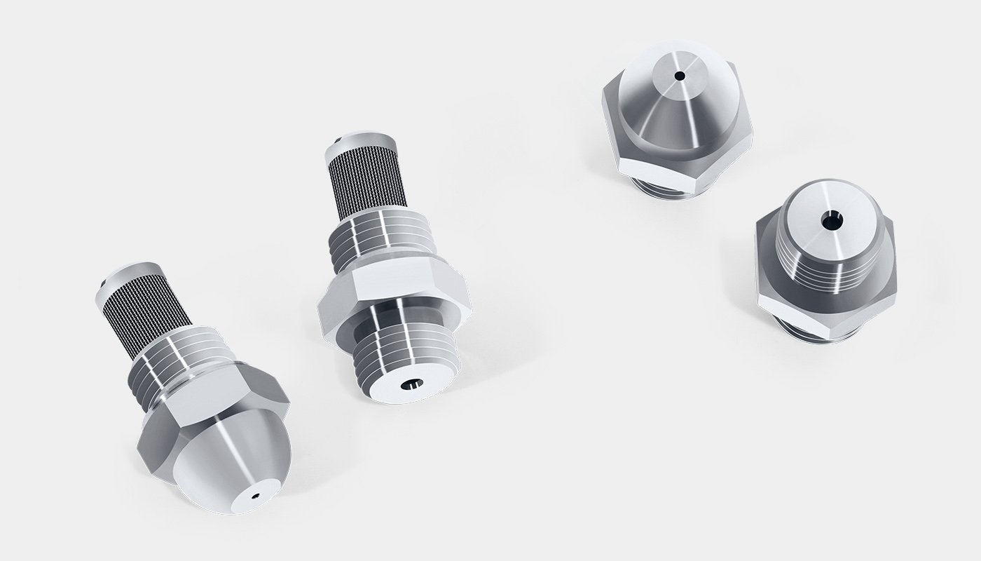 Four SCHLICK hollow cone nozzles. From left to right: Model 121 with filter, Model 121 K with filter and head screw thread, standard Model 121 without and Model 121 with head screw thread.