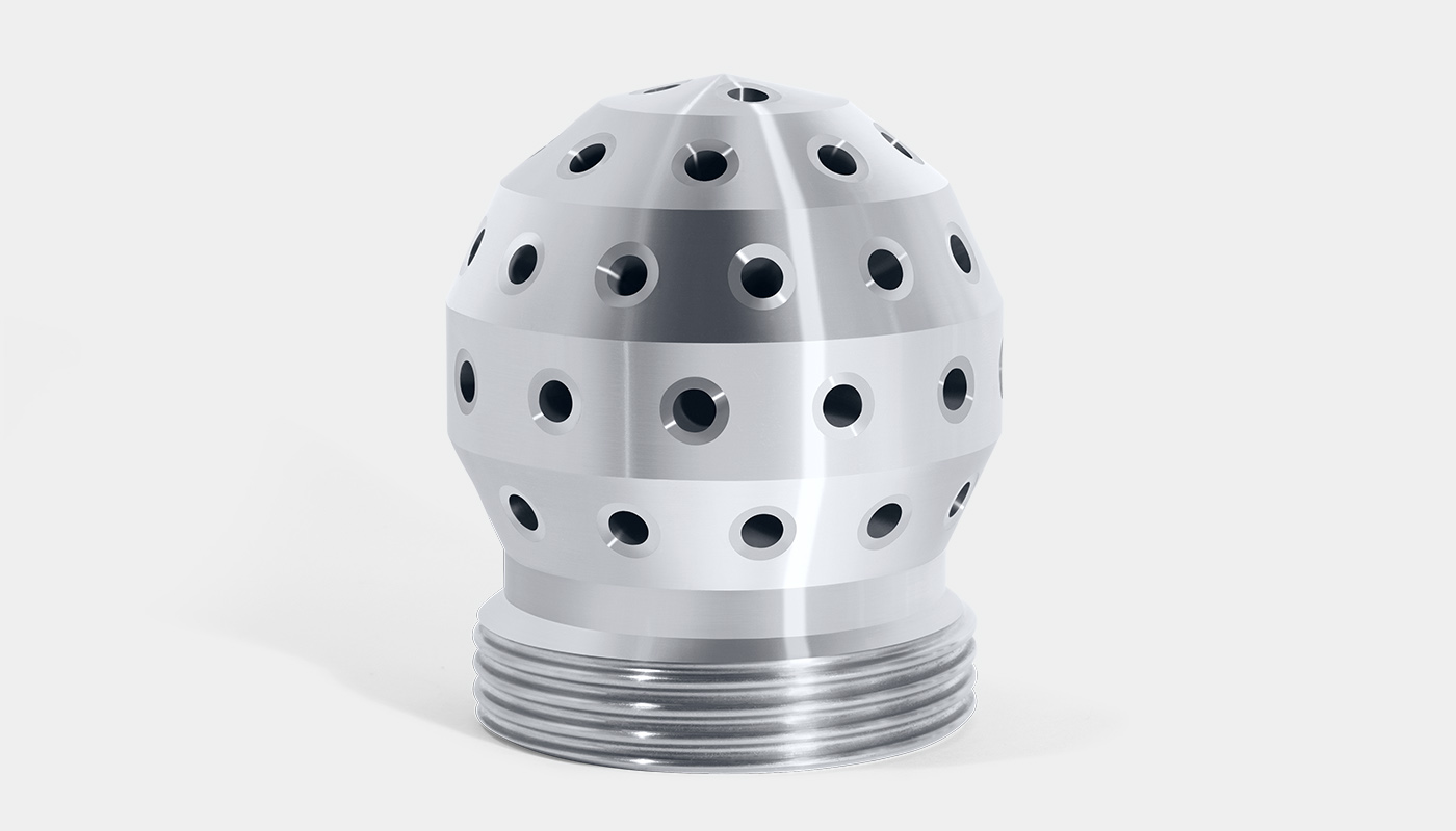 Side view of a SCHLICK nozzle head model 62 with many bore holes. Made from one piece of solid material.