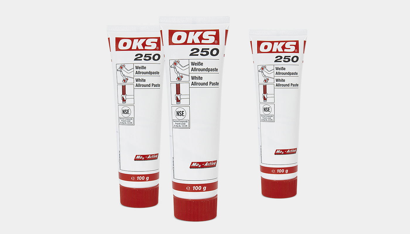 Standing upright: three tubes of special lubrication paste labelled OKS 250.